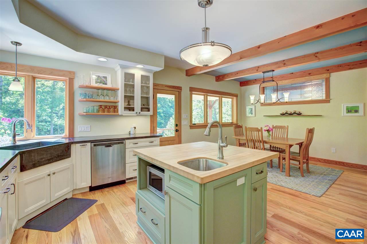 100 Miller School Road Charlottesville, VA 22903 - Photo 15 of 47 a kitchen with a stove a sink dishwasher a dining table and chairs with wooden floor