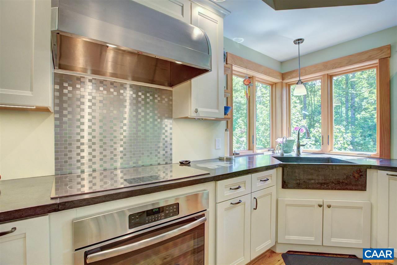 100 Miller School Road Charlottesville, VA 22903 - Photo 17 of 47 a kitchen with stainless steel appliances white cabinets and a window