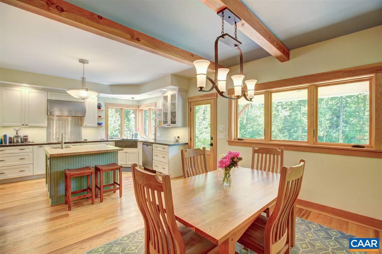 100 Miller School Road Charlottesville, VA 22903 - Photo 18 of 47 a dining room with wooden floor a chandelier a wooden table and chairs