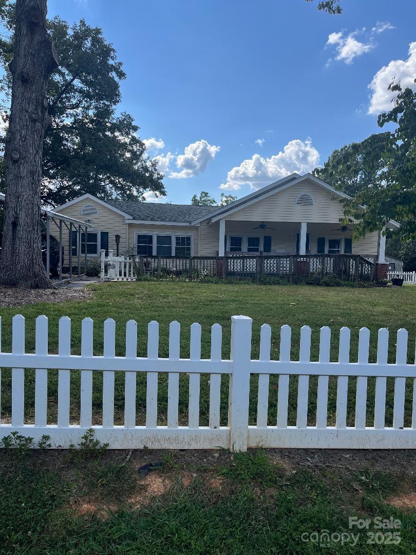 9404 Providence Road South Waxhaw, NC 28173 - Photo 1 of 45 a view of a wooden deck and a yard