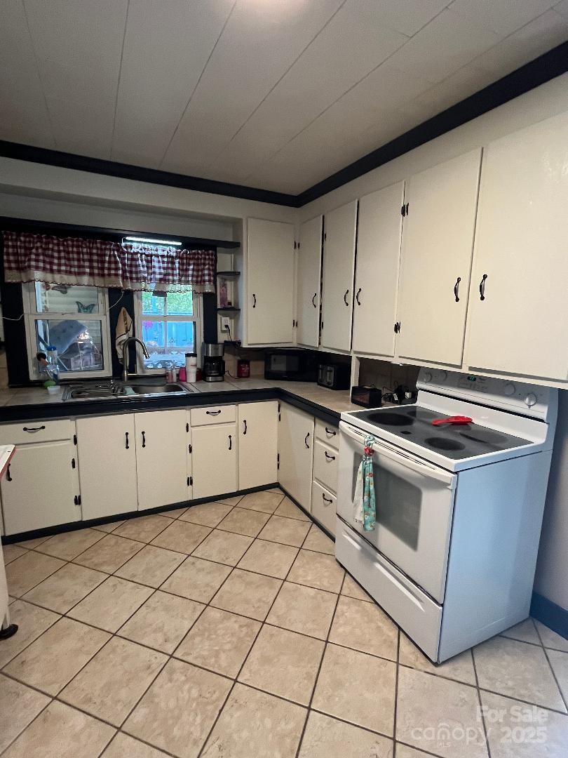 9404 Providence Road South Waxhaw, NC 28173 - Photo 13 of 45 a kitchen with stainless steel appliances granite countertop a sink and a stove
