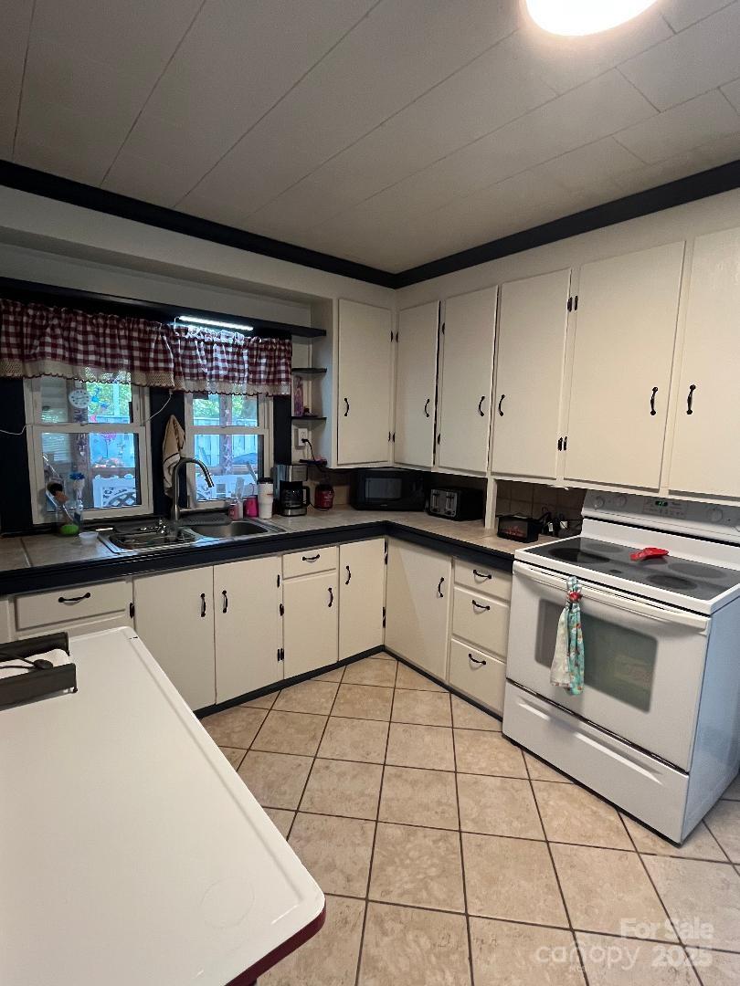 9404 Providence Road South Waxhaw, NC 28173 - Photo 14 of 45 a kitchen with stainless steel appliances a stove a sink and a microwave