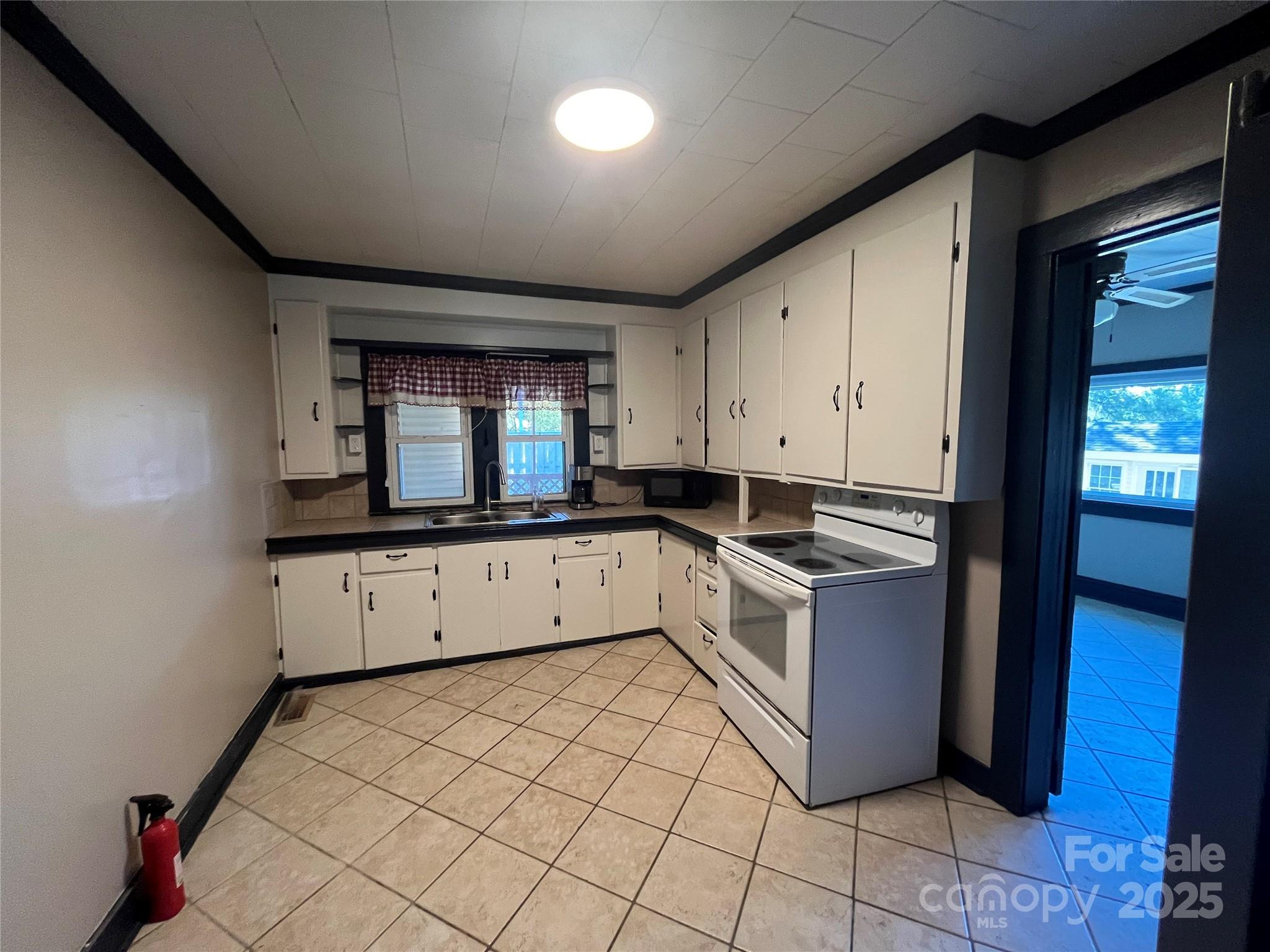 9404 Providence Road South Waxhaw, NC 28173 - Photo 15 of 45 a kitchen with stainless steel appliances granite countertop a stove a sink and a refrigerator