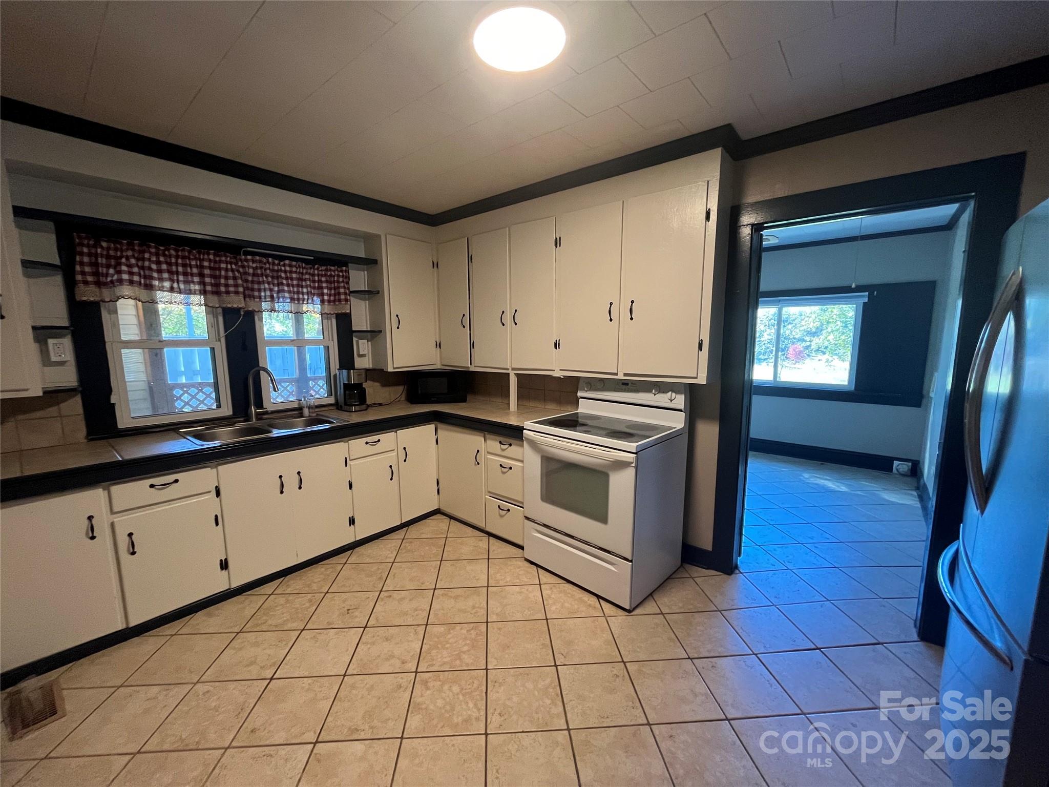 9404 Providence Road South Waxhaw, NC 28173 - Photo 16 of 45 a kitchen with a stove sink and cabinets