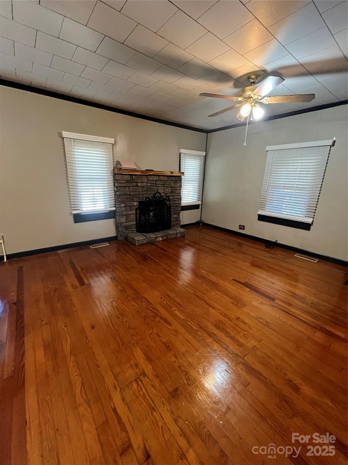 9404 Providence Road South Waxhaw, NC 28173 - Photo 19 of 45 a view of an empty room with wooden floor and a fireplace