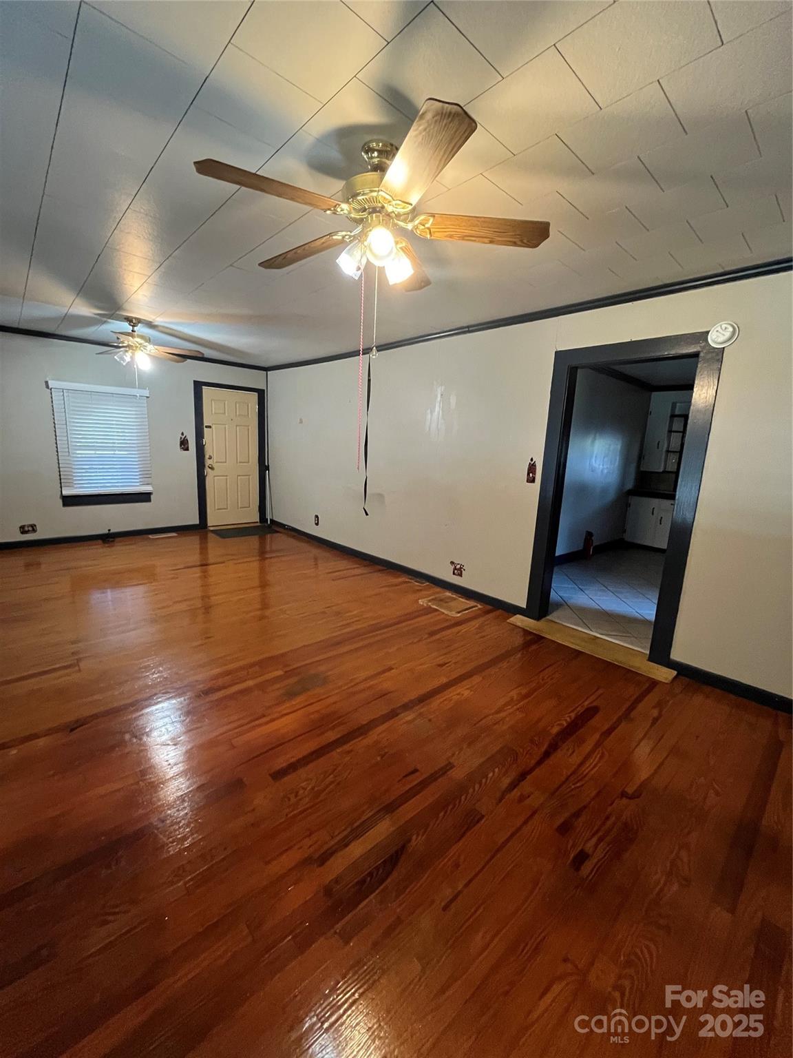 9404 Providence Road South Waxhaw, NC 28173 - Photo 21 of 45 a view of an empty room with wooden floor and a window
