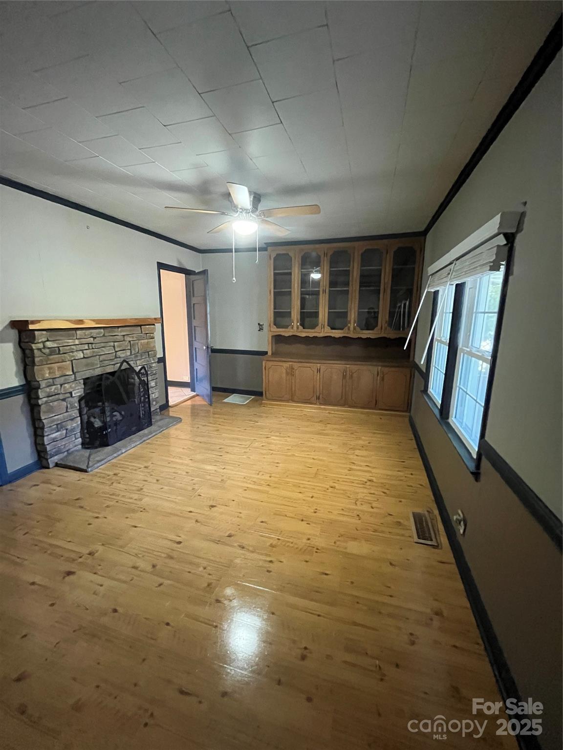 9404 Providence Road South Waxhaw, NC 28173 - Photo 30 of 45 a view of empty room with fireplace and wooden floor