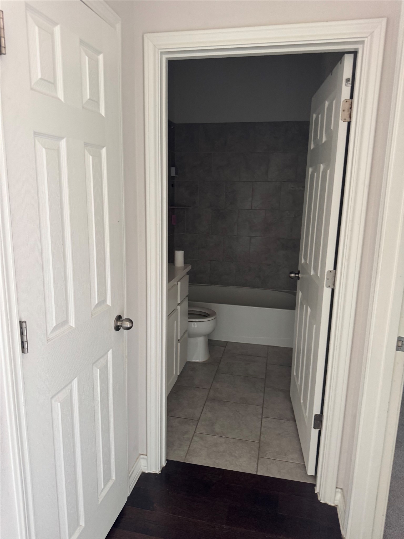 333 Capstone Road Liberty Hill, TX 78642 - Photo 5 of 40 Full bathroom with vanity, light wood-style flooring, and bathtub / shower combination