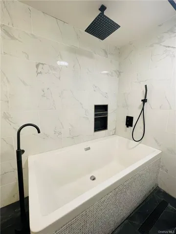 a bathroom with a bathtub and shower