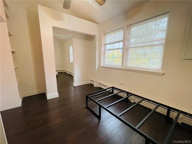 a room with wooden floor and a window