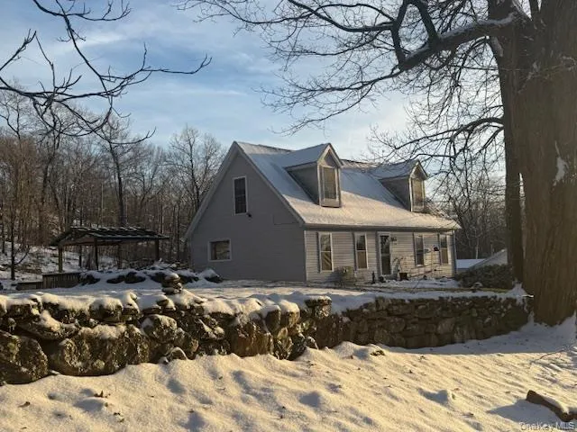 a front view of a house with a yard covered with snow