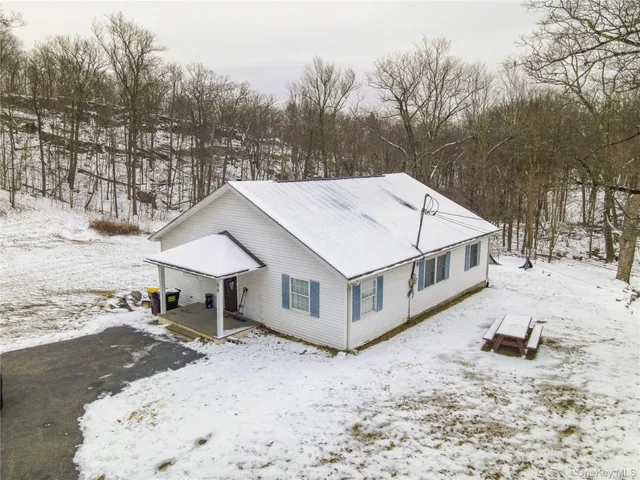a white house that has a tree in the background