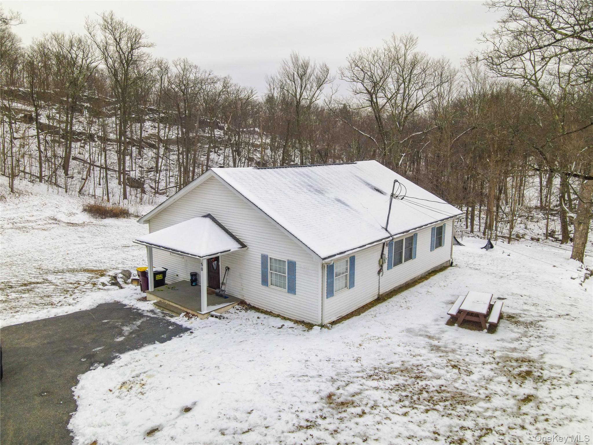 50 Continental Road Warwick, NY 10990 - Photo 20 of 36 a white house that has a tree in the background