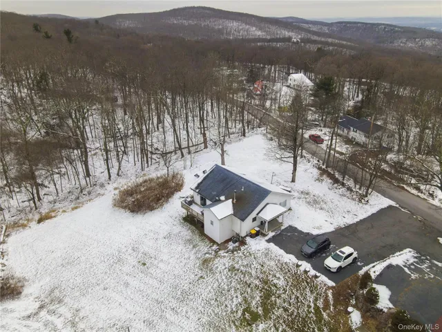 a view of a wooden house with a yard