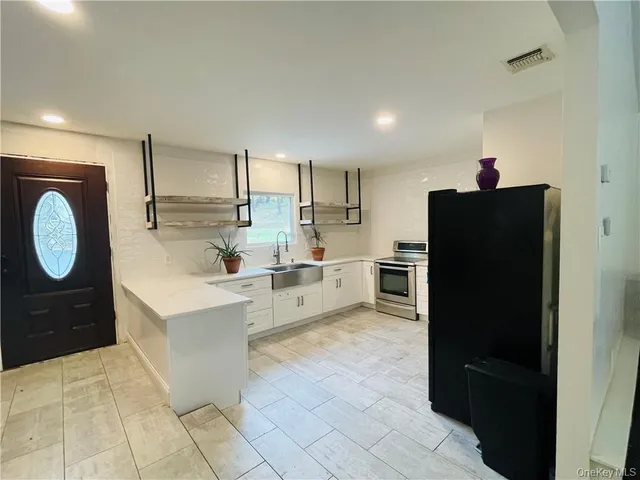 a kitchen with a refrigerator and a sink