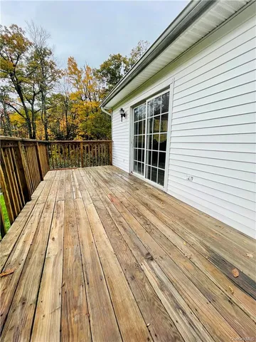 a view of balcony with wooden floor and fence