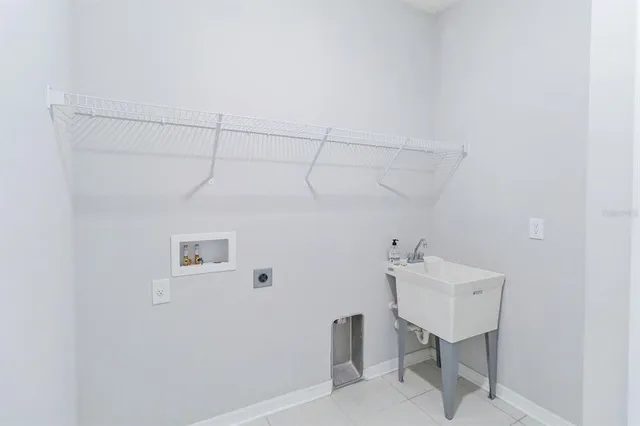 a bathroom with a sink a light fixture and a table