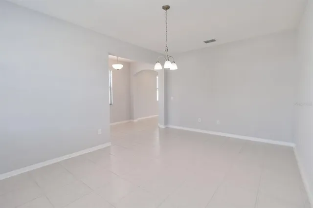a view of a chandelier fan and fire place