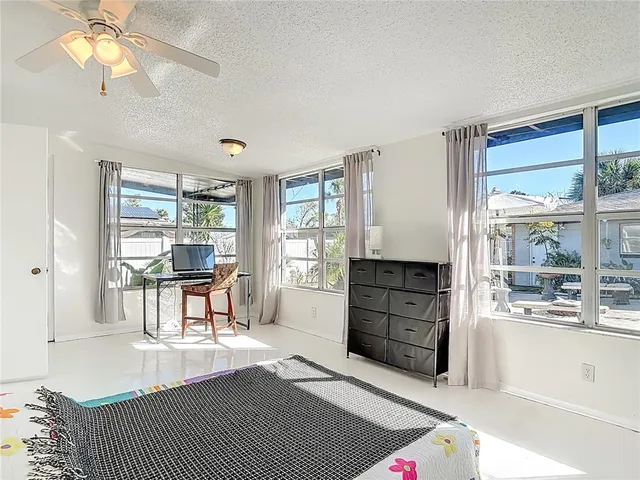 a bedroom with a bed and chandelier