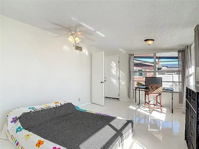 a living room with furniture kitchen and a dining table