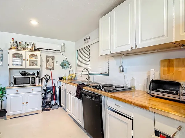 a living room with furniture a flat screen tv and a window