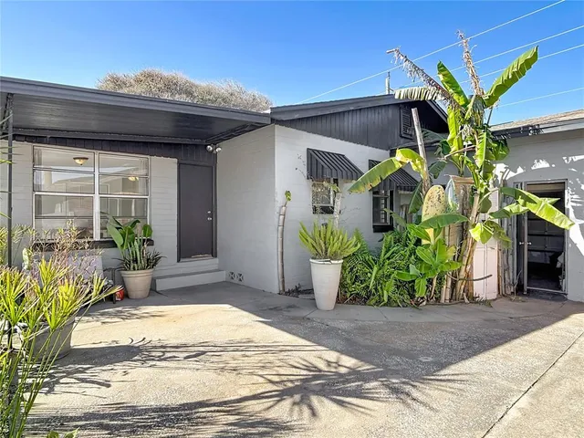 a view of a couple of cars parked in front of a house