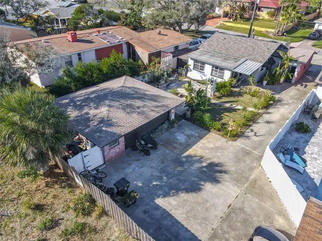 an aerial view of a house with garden space and sitting area