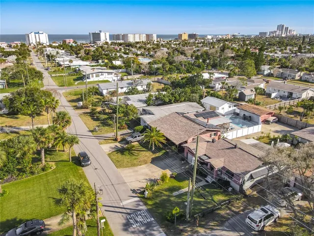an aerial view of a house with a yard swimming pool and outdoor seating