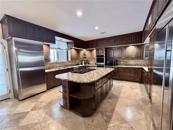 a view of a hallway with entryway wooden floor and a chandelier