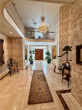 a living room with furniture and a chandelier