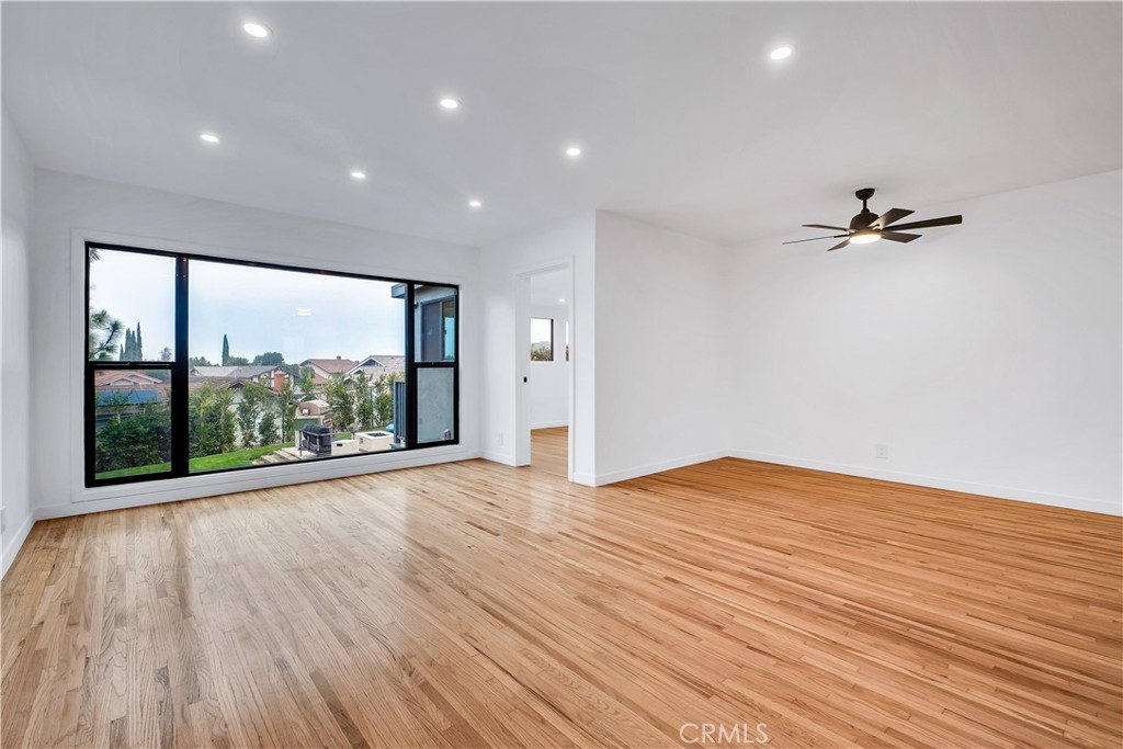 25710 Crest Road Torrance, CA 90505 - Photo 69 of 70 Sunlight pours through this open floor plan of your living room & dining area with refinished original hardwood floors, new baseboards, new oversized window with stunning views, recessed lights and new ceiling fan in dining area.