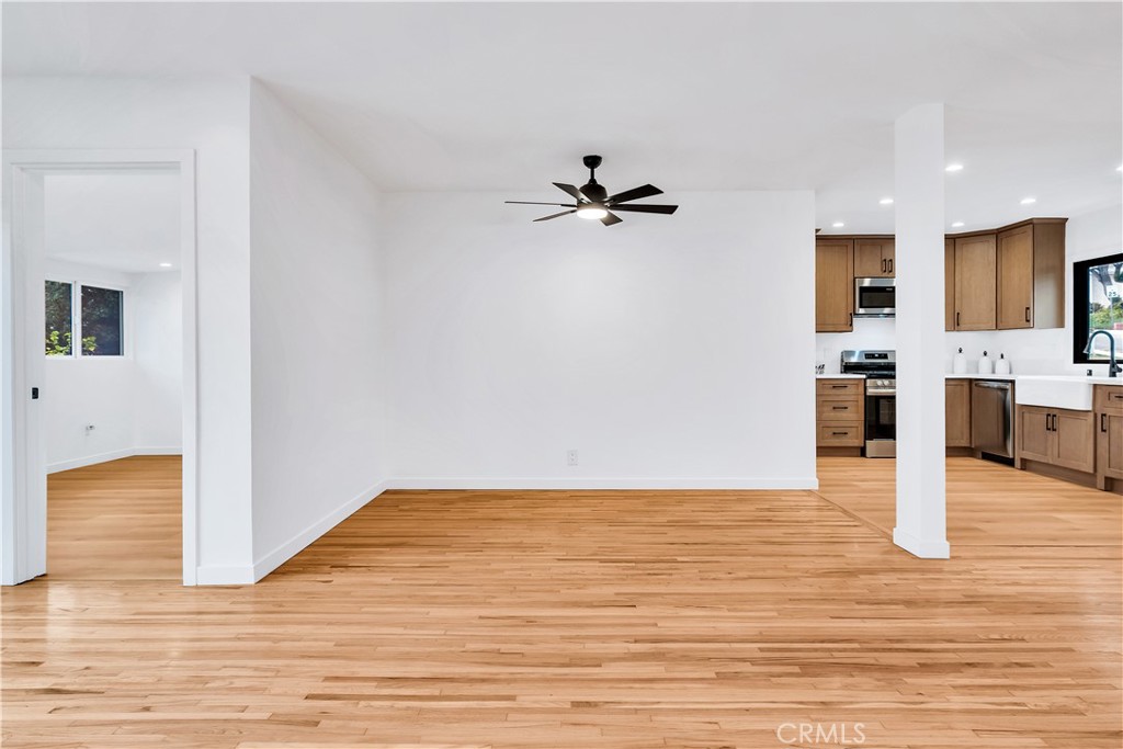 25710 Crest Road Torrance, CA 90505 - Photo 22 of 72 The living room boasts a graceful transition into the dining area, with an open view that enhances the sense of space and connection.