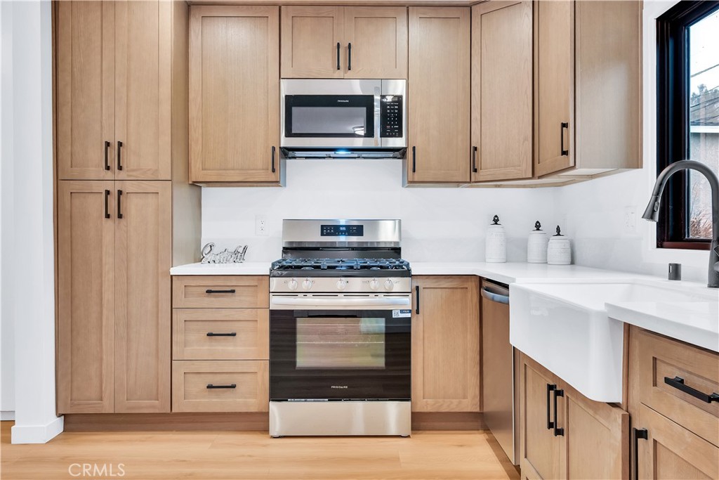 25710 Crest Road Torrance, CA 90505 - Photo 24 of 72 The kitchen has been remodeled for both style and convenience, pantry, new soft closing drawers, stainless steel microwave, stainless steel stove and stainless steel dishwasher.