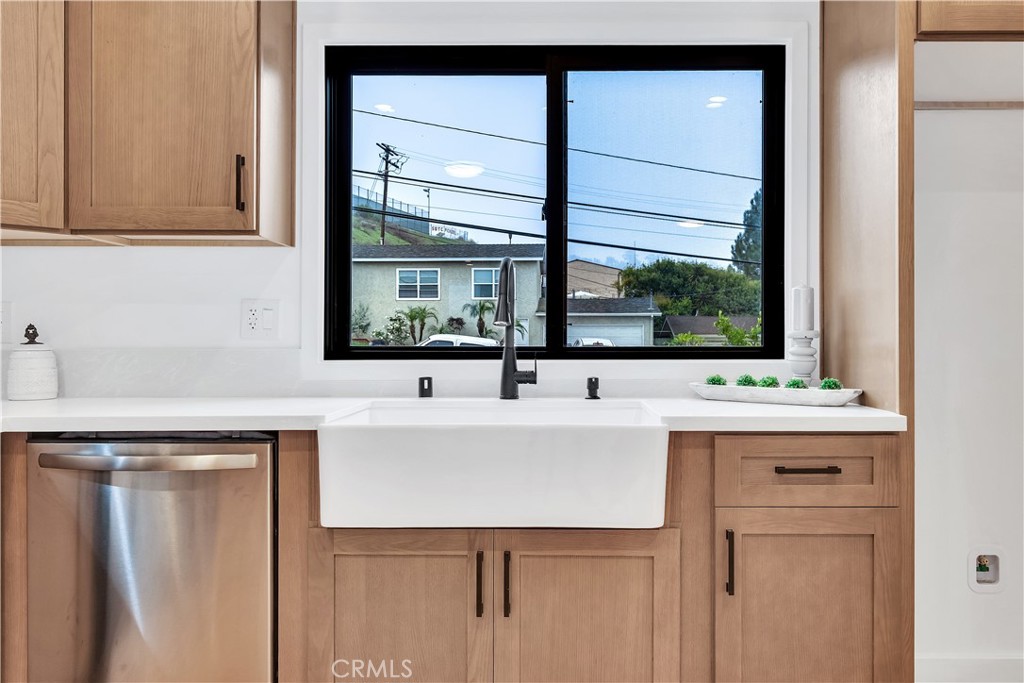 25710 Crest Road Torrance, CA 90505 - Photo 26 of 72 The kitchen highlights a charming farmhouse sink set beneath a new window that offers a lovely view of the front yard, bringing in plenty of natural light and a touch of outdoor charm.
