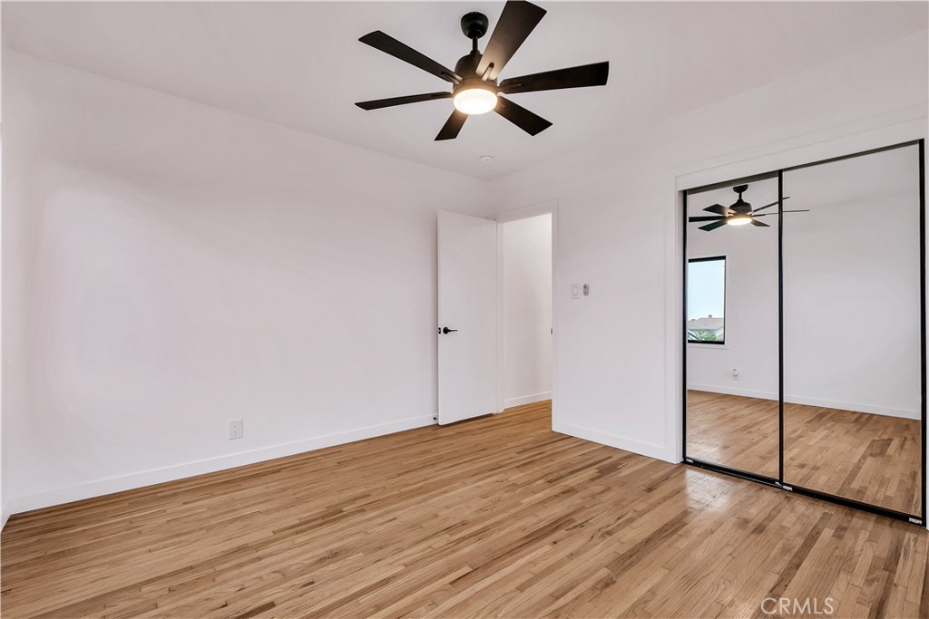 25710 Crest Road Torrance, CA 90505 - Photo 32 of 72 Rear Primary Bedroom #1 with beautiful refinished original hardwood floors, new baseboards, new ceiling fan & new mirror closet doors.