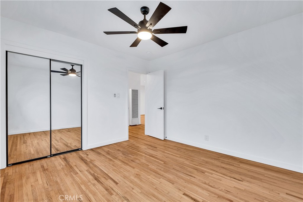 25710 Crest Road Torrance, CA 90505 - Photo 34 of 70 Front North Bedroom with beautiful refinished original hardwood floors, new baseboards, new ceiling fan & new mirror closet doors.