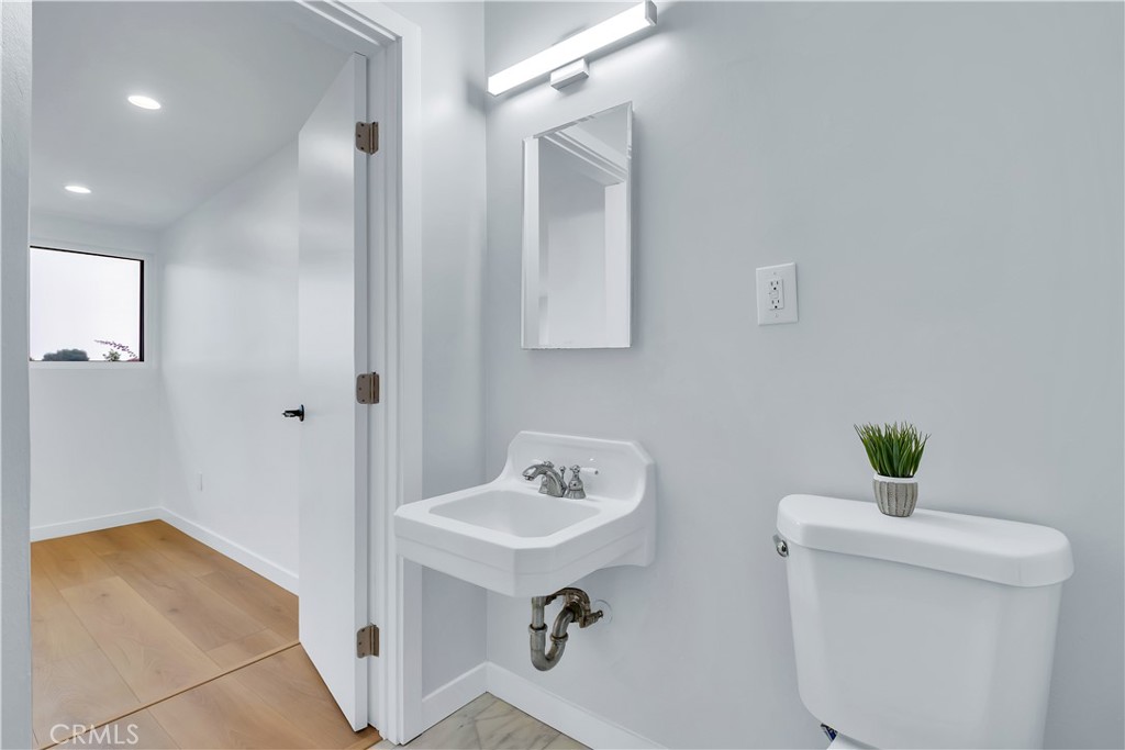 25710 Crest Road Torrance, CA 90505 - Photo 50 of 70 3/4 Bathroom with new light fixture, new toilet & new marble flooring & baseboards.