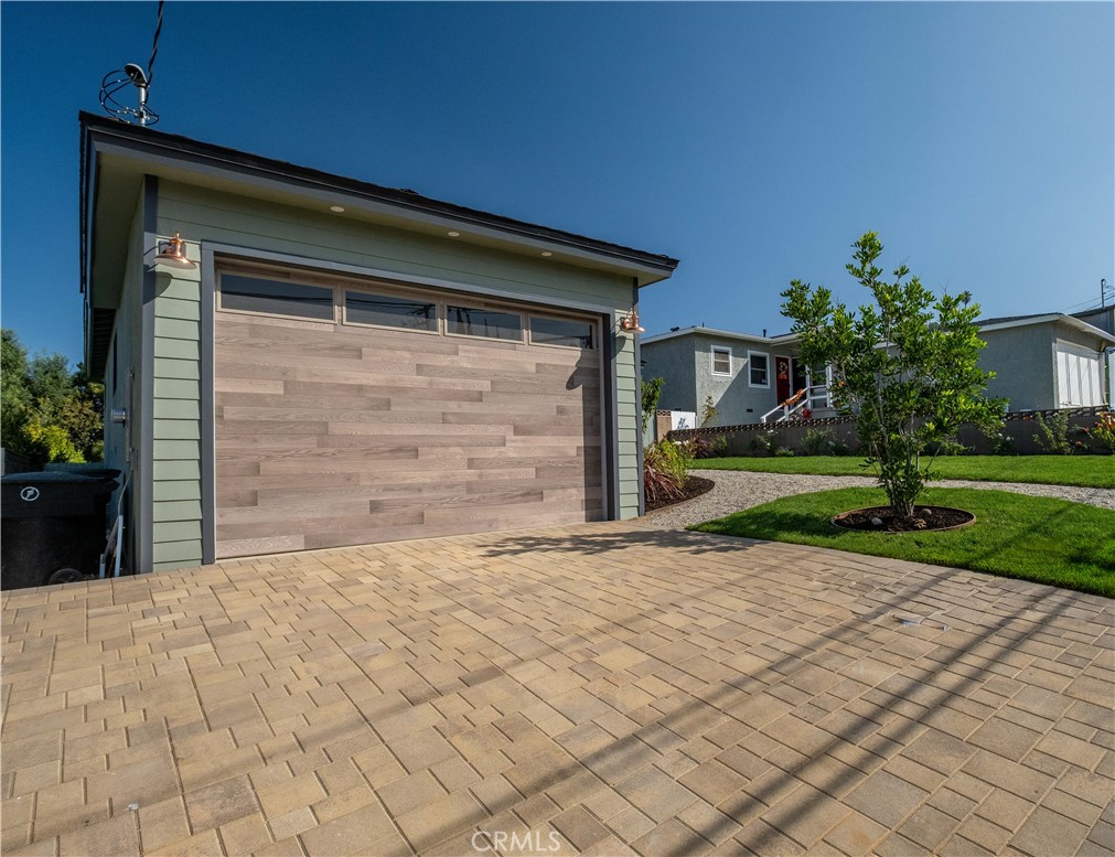 25710 Crest Road Torrance, CA 90505 - Photo 9 of 70 New Paver driveway, new custom Clopay oversized 9ft electric garage door with 2 new exterior designer lighting fixtures, new 200 AMP electrical panel & EV charger in garage.