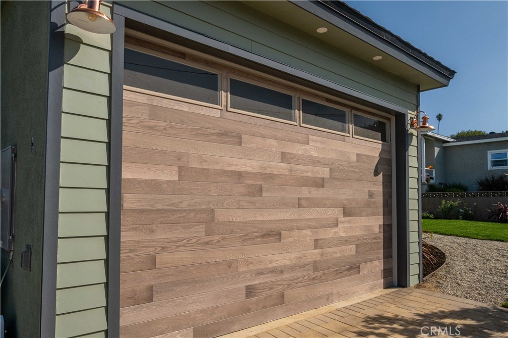 25710 Crest Road Torrance, CA 90505 - Photo 10 of 70 Decorative exterior lights frame the new garage door, adding warmth and character.