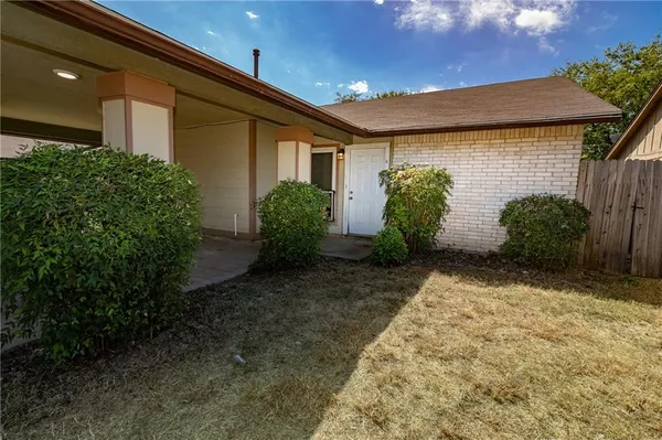 a view of a house with potted plants