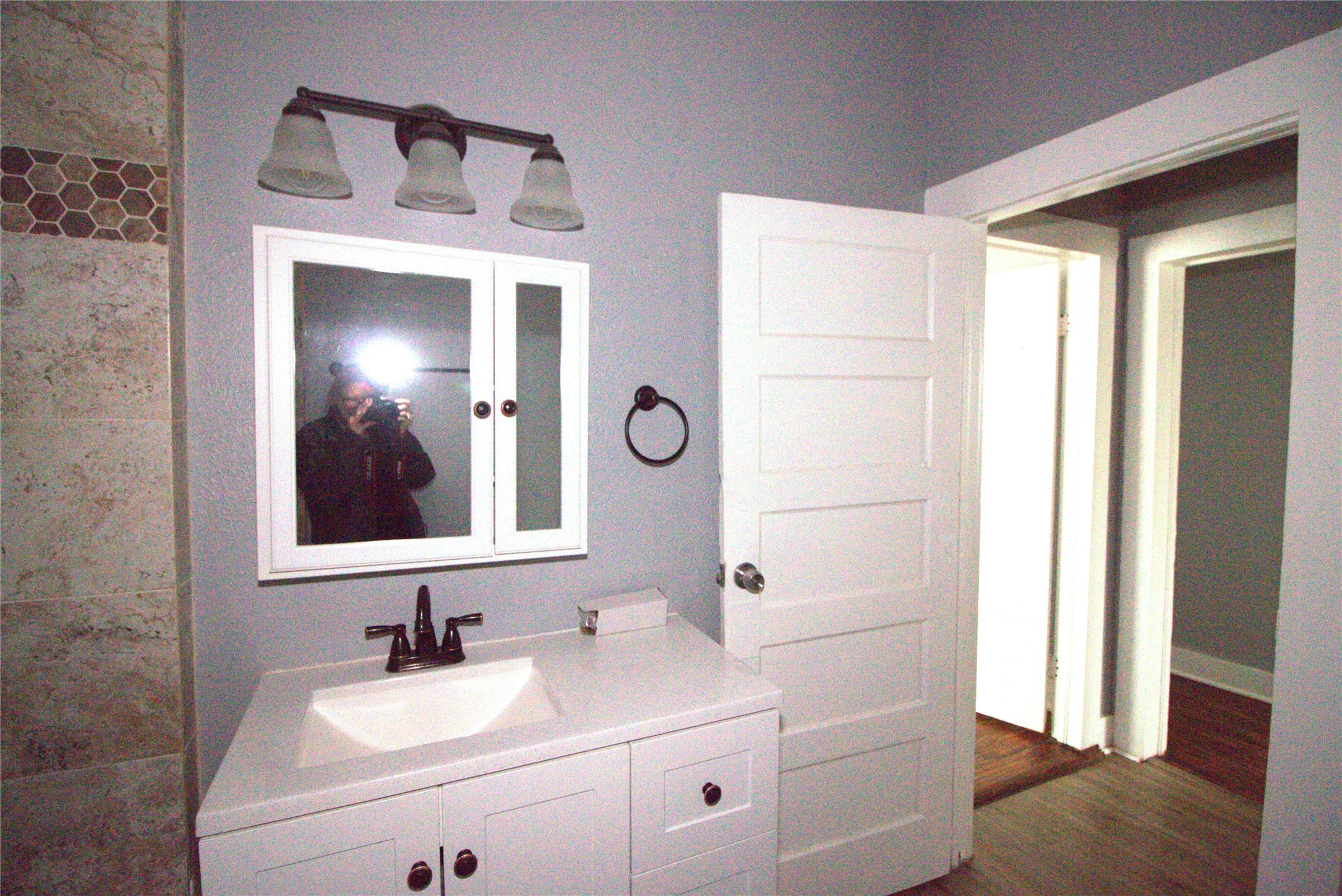 418 3rd Street Humble, TX 77338 - Photo 13 of 20 Discover the charm of this beautifully remodeled bathroom, featuring sleek fixtures, modern lighting, and stylish tile accents.