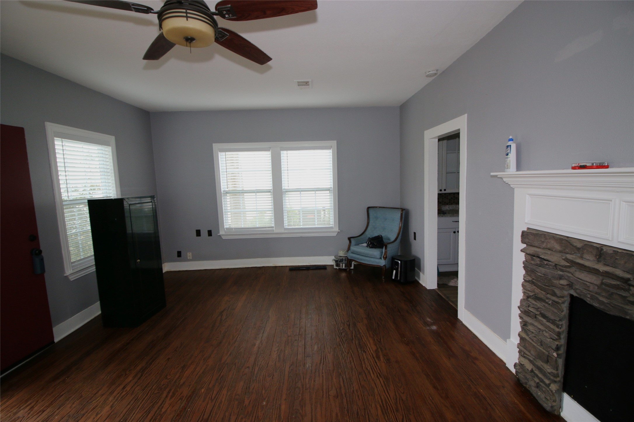 418 3rd Street Humble, TX 77338 - Photo 4 of 20 This inviting living room boasts abundant natural light and charming vintage wood floors, creating a warm and welcoming atmosphere.
