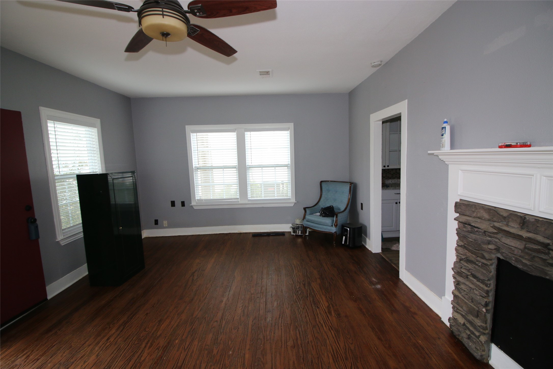 418 3rd Street Humble, TX 77338 - Photo 5 of 20 Step into this cozy living room featuring beautiful old floors abundant natural light through classic windows.