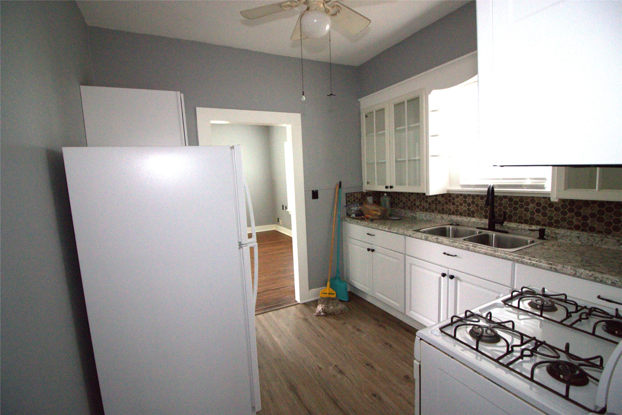 418 3rd Street Humble, TX 77338 - Photo 7 of 20 This inviting kitchen features a sleek refrigerator, efficient gas range, and a pantry