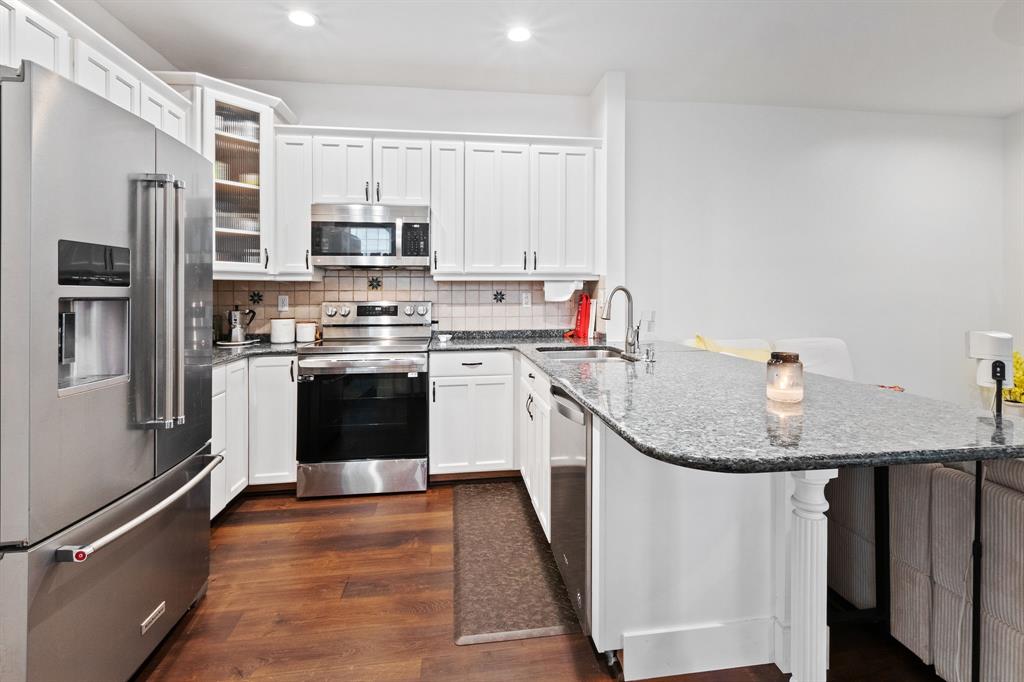 4035 Tree Top Road Cooper City, FL 33026 - Photo 11 of 33 a kitchen with stainless steel appliances granite countertop a stove a sink dishwasher a refrigerator and a microwave