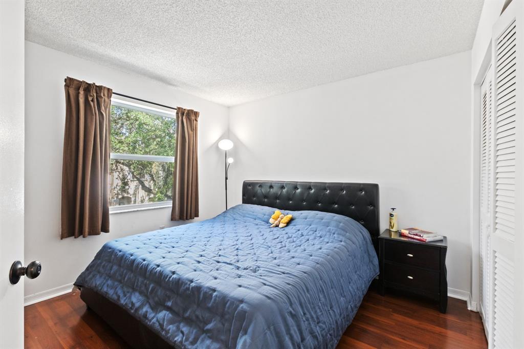4035 Tree Top Road Cooper City, FL 33026 - Photo 21 of 33 a bed sitting in a bedroom next to a window