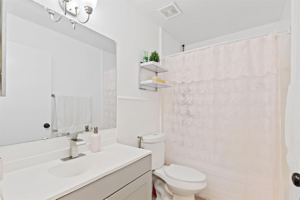 4035 Tree Top Road Cooper City, FL 33026 - Photo 22 of 33 a bathroom with a sink a toilet and shower curtain