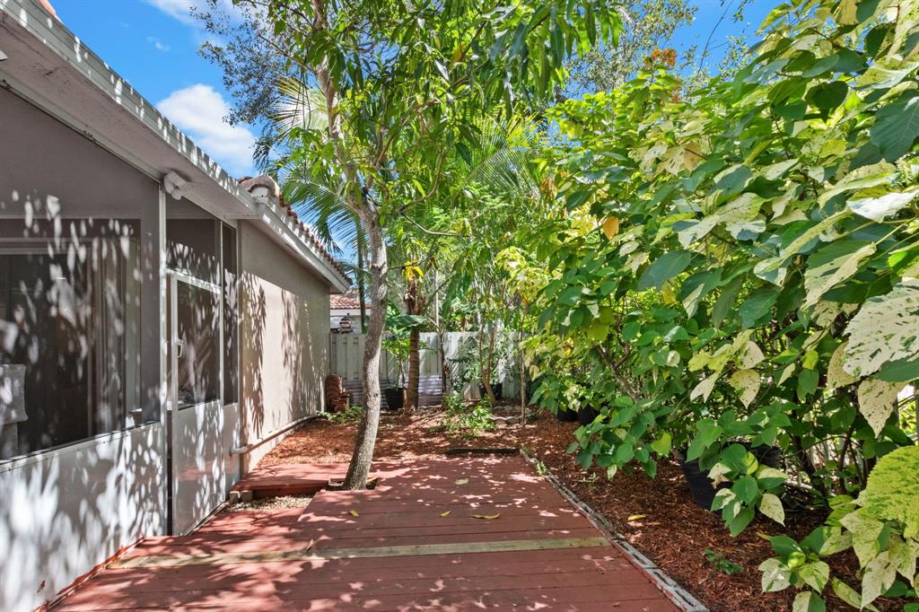 4035 Tree Top Road Cooper City, FL 33026 - Photo 27 of 33 a view of a house with backyard and tree