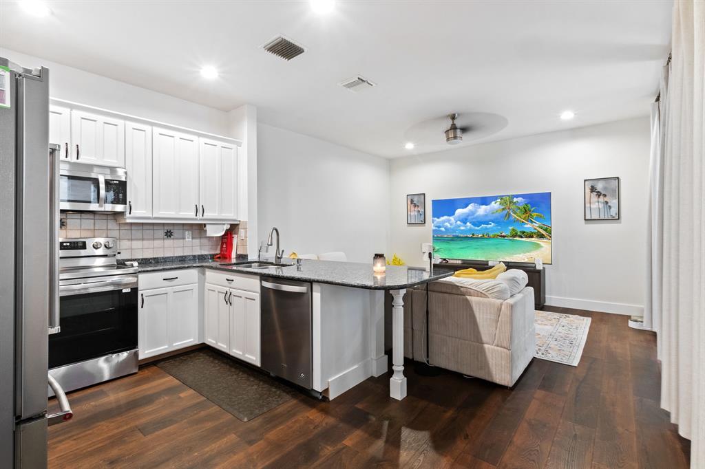 4035 Tree Top Road Cooper City, FL 33026 - Photo 8 of 33 a kitchen with stainless steel appliances a stove top oven and a refrigerator