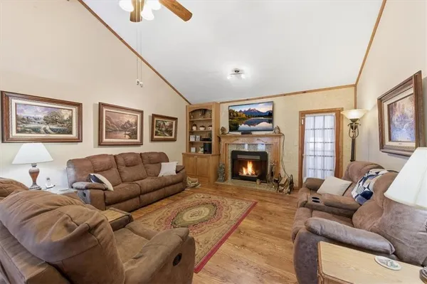 a view of a dining room with furniture and a chandelier fan